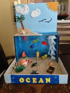 an ocean scene made out of cardboard and sand