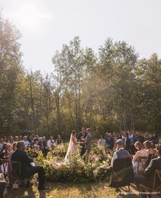 a bride and groom standing in front of an outdoor ceremony