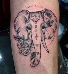 an elephant with roses on it's head and the words love is in the middle