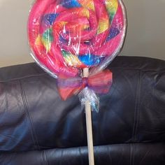 a lollipop sitting on top of a black leather couch