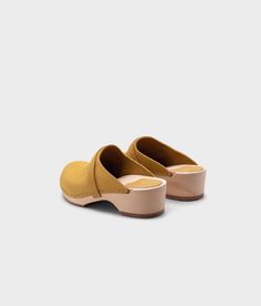 The best clogs for all occasions. Stylish with a nod to the past and an eye towards the future. With a handcrafted design, versatile colors, and comfortable wooden soles, these classic wooden clog mules will last you for years to come. Clog measurements:Heel height: 1 3/4” (4.5 cm)Toe height: 1 5/8″ (4.1 cm)Fit:RegularLeather:Nubuck leatherClogs consist of:Base: European Lime WoodSole: Rubber soleFastening: Staples Clog Mules, Royal Yellow, Cork Sandals, Wooden Clogs, Clog Sandals, An Eye, Boot Shop, Mule, Clogs