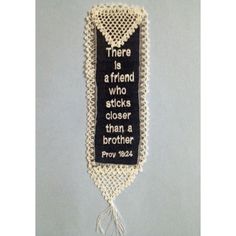 there is a friend who sticks closer than a brother cross stitched on the wall