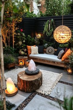 an outdoor living area is lit up with candles and lights in the middle of it