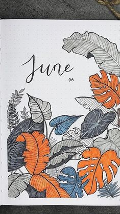 an open notebook with the word june written on it next to a pen and pencil