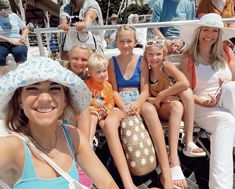 a group of people sitting next to each other on top of a boat in the water