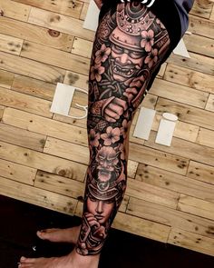 a man's leg with tattoos on it