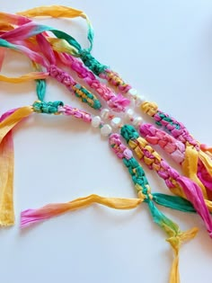 multicolored bracelets with pearls and beads on white surface