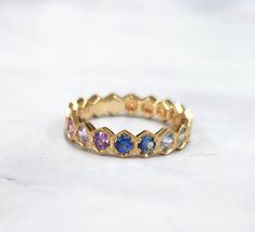 Taste the rainbow! Amazing color fade of multi color sapphires  set in 18k yellow gold 15 sapphires weigh ~1.60 carats total Each stone is set in a hexagon frame with delicate mil grain  All natural, clean and bright stones Ring size US 6, EU 52 (can be sized upon request) Stamped 18K in shank Style Theory, Sapphire Eternity Band, Flower Diamond Ring, Sapphire Eternity Ring, Saphir Ring, Rainbow Sapphires, Rainbow Rings, Taste The Rainbow, Eternity Band Ring