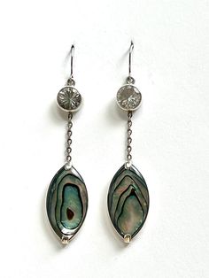 Faceted crystal quartz & abalone dangle earrings set in sterling silver. Hand made. Silver Faceted Fine Jewelry, Silver Long Drop Gemstone Jewelry, Iridescent Elegant Jewelry For Anniversary, Elegant Mother Of Pearl Jewelry, Formal Silver Mother Of Pearl Jewelry, Elegant Iridescent Jewelry For Anniversary, Iridescent Teardrop Jewelry For Formal Occasions, Elegant Pierced Jewelry In Mother Of Pearl, Silver Faceted Dangle Jewelry