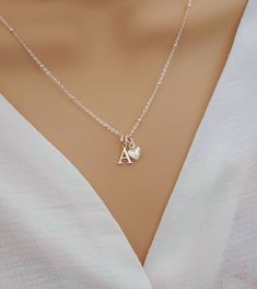 💖 Imagine the moment when you reveal this stunning initial & heart necklace... So pretty and absolutely gorgeous, she's sure to fall in love upon first glance!   💖 The most beautiful gift for yourself or someone special. Such a classy and elegant necklace she is sure to treasure forever. Delight her today with a precious and personalised gift.  Why Choose Our Initial & Heart Necklace? ✨ Elevate your style effortlessly ✨ A heartfelt gift that shows her how special she is ✨ Premium Quality Sterl Sterling Silver Initial Pendant Charm Necklace For Mom, Mother's Day Silver Initial Pendant Necklace, Silver Initial Pendant Necklace For Mom, Delicate Silver Pendant Initial Necklace, Initial Pendant Charm Necklace As Gift For Her, Silver Initial Pendant Necklace, Gift For Mom, Silver Initial Necklace Gift For Mom, Mother's Day Sterling Silver Charm Necklaces, Silver Initial Necklace For Mom