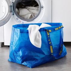 a blue bag sitting next to a washing machine