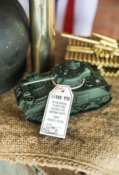 a green toy tank sitting on top of a table