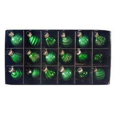 twelve green christmas ornaments in a black box