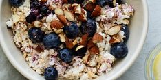 a bowl filled with oatmeal, blueberries and almonds