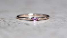 "A dainty marquise pink sapphire is at the center of our \"Wink\" ring, giving you just a little wink of sparkle! - Marquise stone measures 4mm x 2mm - Handcrafted out of 14K yellow, rose, or white gold - Round band measures 1.2mm in width Processing Times - Current processing time is 1 - 3 weeks. Each Item is handmade to order with love and care! In Stock Items - Contact Liesel Love with any rush order questions, or to see if we have anything ready made and in stock. Returns - Liesel Love does Pink Marquise Gemstone Jewelry, Pink Marquise Jewelry For Anniversary, Pink Marquise Ruby Ring Fine Jewelry, Fine Jewelry Pink Marquise Ruby Ring, Pink Marquise Ring For Anniversary, Pink Marquise Promise Ring, Pink Marquise Cut Jewelry As Gift, Pink Marquise Ring For Gift, Pink Marquise Rings For Gifts