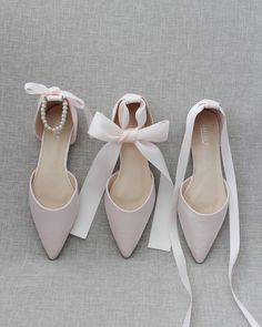 three pairs of shoes with bows and pearls