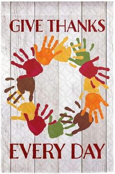 a wooden sign that says give thanks every day with handprints on the front