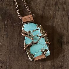 This is a lovely raw looking turquoise with  natural inclusions held  with copper 'arms'.  The Turquoise matches brilliantly with copper...which I only just discovered after 10 years making jewellery so I think there will be more in  the pipeline for sure..The turquoise has been sanded at the edges so it doesnt catch on clothing and measures 5cm x 3cm.  Copper chain is 62cm long only shipping to US and Australia sorry Earthy Turquoise Necklace As A Gift, Earthy Turquoise Necklace For Gift, Rustic Turquoise Necklace With Natural Stones For Gift, Rustic Turquoise Necklace For Gift, Rustic Turquoise Jewelry With Patina, Unique Hand Forged Turquoise Necklace, Handmade Turquoise Necklace With Copper, Bohemian Hand Forged Turquoise Necklace, Handmade Copper Turquoise Necklace