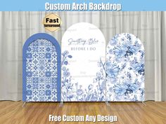 custom arch backdrop with blue and white flowers on it, in front of a wooden floor