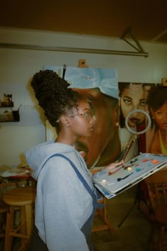 a woman is painting in an art studio