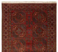 an antique rug with red and blue colors