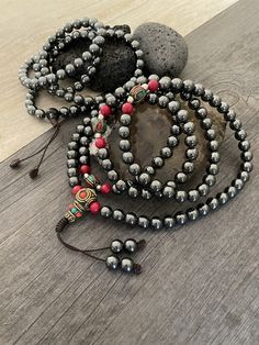 Unique Protection Mala necklace, made with Hematite stone beads. A necklace that will keep you in style and grounded at the same time, as you can use this 108 mala necklace for metidating. A perfect gift for your love ones. You can choose between the mala that has Hematite and a mix of red beads, or the one that is just Hematite all around. The just stone Mala is 40.6cm- 16 inch long The stone and red Mala is 27cm- 18.5 inch long A most have addition to your jewelry collection. ⚡️Join Akashi's V Bohemian Beaded Necklaces With 8mm Beads For Jewelry Making, Beaded Crystal Necklaces With Round Beads For Festivals, Traditional Beaded Crystal Necklaces With Round Beads, Festival Beaded Necklace With Round Beads, Traditional Beaded Crystal Necklaces, Spiritual Round Beaded Necklace With Colorful Beads, Spiritual Polished Round Bead Jewelry, Spiritual Polished Round Beads Jewelry, Spiritual Colorful Beaded Necklaces