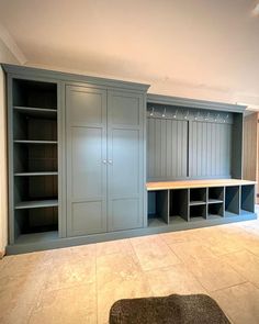 an empty room with several cabinets and shelves in it, including a rug on the floor