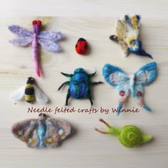 needled felted crafts by whinee are displayed on a wooden surface with the words needled related crafts by whinee