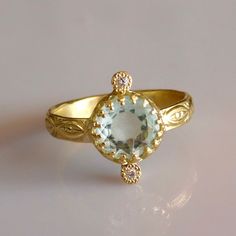 Fine beautifully detailed 18k Solid Gold AAA Aquamarine Solitaire Ring with Diamonds. 18k Solid Gold 2 x VS SI 0.01ct Natural Brilliant Ethically sourced Diamonds Free Sizing included from 4us to 7.5us Free worldwide Shipping Custom orders Welcomed! Aquamarine;  Aquamarine is a stone of breath, Confidence, clarity and Love. For more rings: https://www.etsy.com/shop/templejewelsibiza/items?section_id=21449468 To my shop: https://www.etsy.com/shop/templejewelsibiza 14k Gold Topaz Ring With Rose Cut Diamonds, Aquamarine Diamond Ring With Diamond Accents, Gold Aquamarine Promise Ring, Gold Aquamarine Birthstone Ring In Elegant Style, Gold Diamond Ring With Blue Topaz In Round Cut, Yellow Gold Blue Topaz Diamond Ring, Gold Rings With Halo Setting And Blue Topaz, Elegant Gold Birthstone Ring With Blue Topaz, Yellow Gold Diamond Ring With Blue Topaz