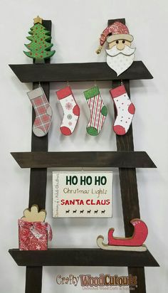 a shelf with christmas stockings, stockings and santa clause decorations on it's sides