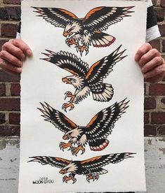 a person holding up a poster with eagle tattoos on it