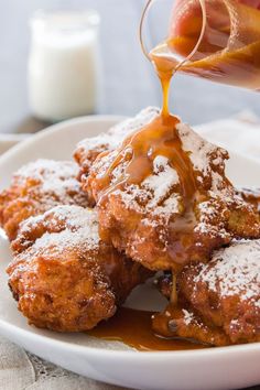 someone is dipping some kind of food on top of another plate with sauce in it