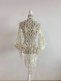 "This is a beautiful vintage soft mohair crochet lace shawl in off white color. This fluffy lace shawl is made of soft warm yarn which will keep you cozy during the winter days and yet it will make you feel gorgeously stylish. This bohemian shawl has a fishnet floral pattern. Perfect mohair wrap for the fall/ winter season. This boho shawl will add a pop of romantic cottagecore style to your outfit.   This women triangle shawl is the perfect gift for your sister, mother or grandmother. Era: Y2K Condition: This mohair shawl is in great vintage condition with some signs of wear. Perhaps the fabric was fluffier before, but it still looks awesome.  Measurements:  Length: 65\" / 165 cm  Width: 41.3\"  /105 cm  Colors: off white Material: not marked feels like mohair wool Shipping: I will ship y Traditional White Shawl For Summer, Fitted Bohemian Shawl For Wedding, Traditional White Summer Shawl, White Bohemian Shawl For The Beach, White Bohemian Shawl For Festivals, Handmade White Shawl For Spring, White Bohemian Shawl For Beach, Bohemian Beige Shawl For Wedding, Beige Bohemian Shawl For Wedding