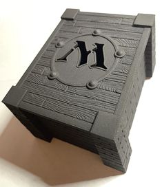 a close up of a wooden box with the letter n on it's side