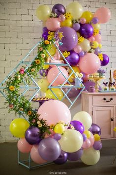 a room filled with lots of balloons and flowers