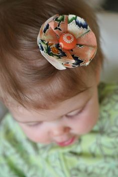 a baby with a flower in it's hair