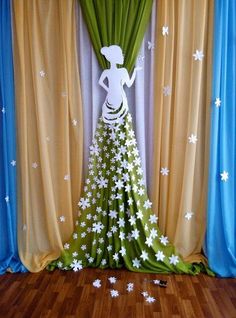 a woman standing in front of a curtain with flowers on it and stars all over the floor