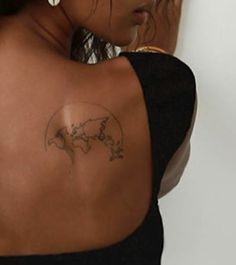 a woman with a world map tattoo on her back