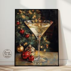 a painting of a martini glass next to christmas ornaments