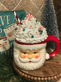 a ceramic santa clause mug sitting on top of a table