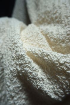 a close up view of a white blanket