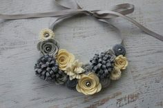 a necklace made out of fabric and flowers