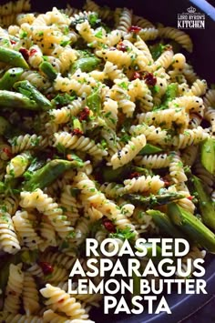 a blue bowl filled with pasta and asparagus