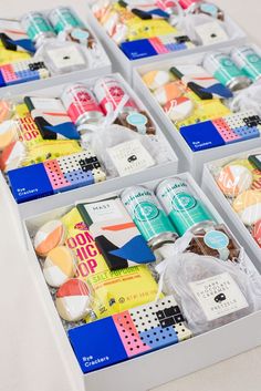 four boxes filled with assorted items on top of a white countertop next to each other