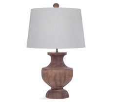 a wooden table lamp with a white shade on the base and a light grey fabric shade