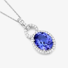 14K White Gold Tanzanite Pendant, Genuine Tanzanite and Diamond Gold Pendant Necklace, Statement Pendant, Tanzanite Wedding Pendant Claim royal status wearing this eye-catching halo pendant necklace. Presenting a 2.41 ct. t.w. oval genuine tanzanite set in 14k white gold with fine finish. A totally regal piece that will make a glowing statement. 14k gold tanzanite and diamond pendants are a gorgeous and elegant way to adorn your neck and enhance your outfit. These pendants feature a natural tanz Brilliant Cut Tanzanite Necklace For Wedding, Anniversary Tanzanite Necklace With Brilliant Cut, Tanzanite Gemstone Necklace For Wedding, Wedding Tanzanite Pendant Necklace, Tanzanite Halo Jewelry For Wedding, Wedding Tanzanite Halo Jewelry, Tanzanite Halo Wedding Jewelry, Fine Jewelry Tanzanite Necklaces For Wedding, Formal Tanzanite Necklaces