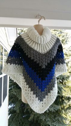 a crocheted ponchy is sitting on the porch