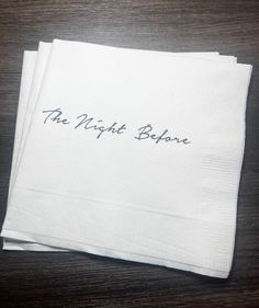 two napkins with the words the night before written on them sitting on a table