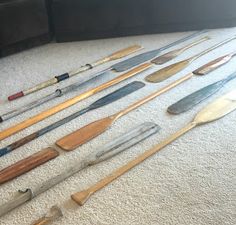 many different types of knives and spoons laid out on the floor