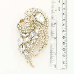 "Crystal gold brooch, Art Deco wedding bridal jewelry rhinestone embellishment, which can be used for your DIY project - gold wedding, bridal bouquet, dress sash, ring pillow, cake decorations, pillow and clutch decor, crafts, scrap booking, jewelry gift and much more. Size: 3 1/2\"H x 2\"W Stones color: Crystal clear Metal: Gold plated This rhinestone brooch can be ordered with pin in the back to add to wedding gown or dress sash, to wire into brooch bouquet, or any number of other craft projec Gold Rhinestone Pins For Wedding, Gold Rhinestone Wedding Pins, Gold Wedding Pins With Rhinestones, Elegant Gold Pins With Rhinestones, Gold Crystal Brooch Jewelry, Gold Crystal Brooches For Formal Occasions, Wedding Crystal Brooch Pins, Gold Crystal Jewelry With Brooch, Wedding Crystal Pins With Rhinestones